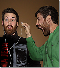 Man yelling into another's ear after removing their headphones--silly stuff (from Flickr)